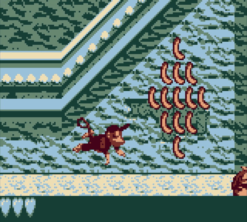 Donkey Kong running along a stone ledge in Donkey Kong Land, with a diamond formation of bananas ahead and detailed patterned backgrounds behind.