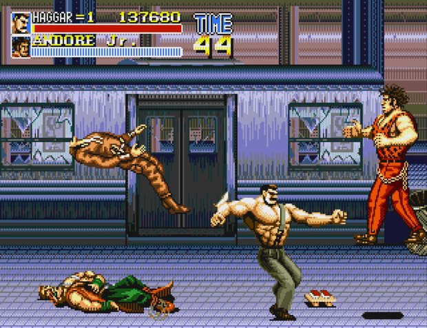 Final Fight CD gameplay: Haggar throwing an enemy through the air on a rainy street, with Andore Jr.'s health bar showing at the top.