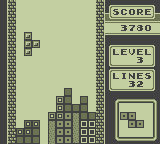 Tetris running on the Game Boy: falling blocks on a green monochrome screen, with score, level and lines counters.