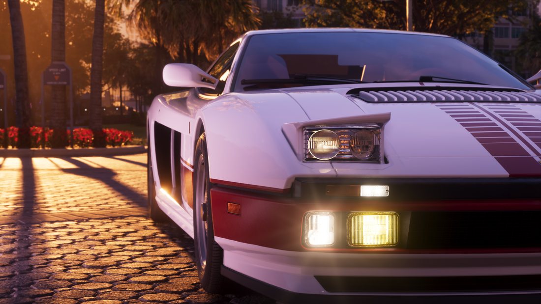 A white and red eighties-style wedge supercar parked on cobbles at golden hour, headlights and fog lamps lit, palm trees casting long shadows.