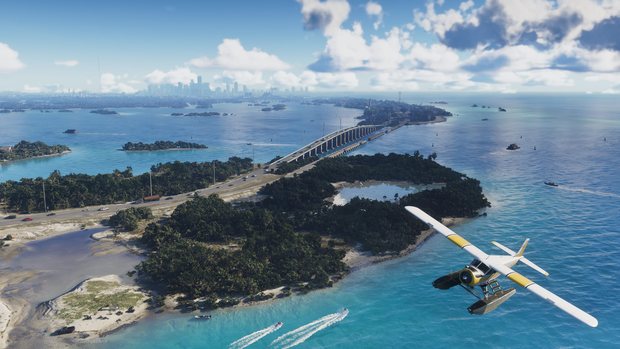 A yellow and white seaplane banking over turquoise water and a long causeway bridge, with the Vice City skyline on the horizon.