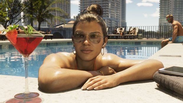 Lucia leaning on the edge of a rooftop swimming pool in aviator sunglasses, a strawberry cocktail in the foreground and tower blocks behind.