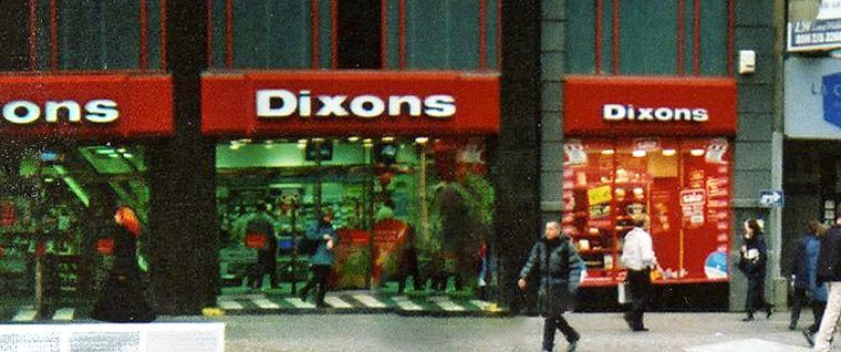 The frontage of a Dixons electrical shop, with the blue and white Dixons sign above the windows.