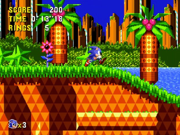 Sonic running through Palmtree Panic in Sonic CD, with orange rock, green grass and palm trees under a deep blue sky.