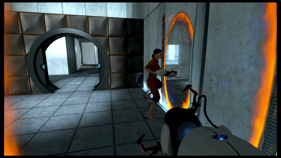 A first-person view in Portal: Chell, in an orange jumpsuit, steps out of a glowing orange portal on the wall while holding the portal gun, with a round test chamber exit ahead.